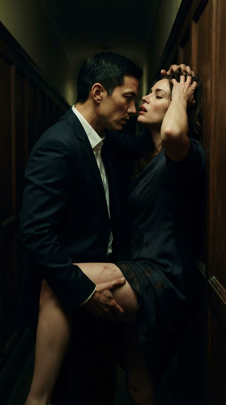 The man's knee presses between the woman's legs in the hallway, her head falling back against the wall.