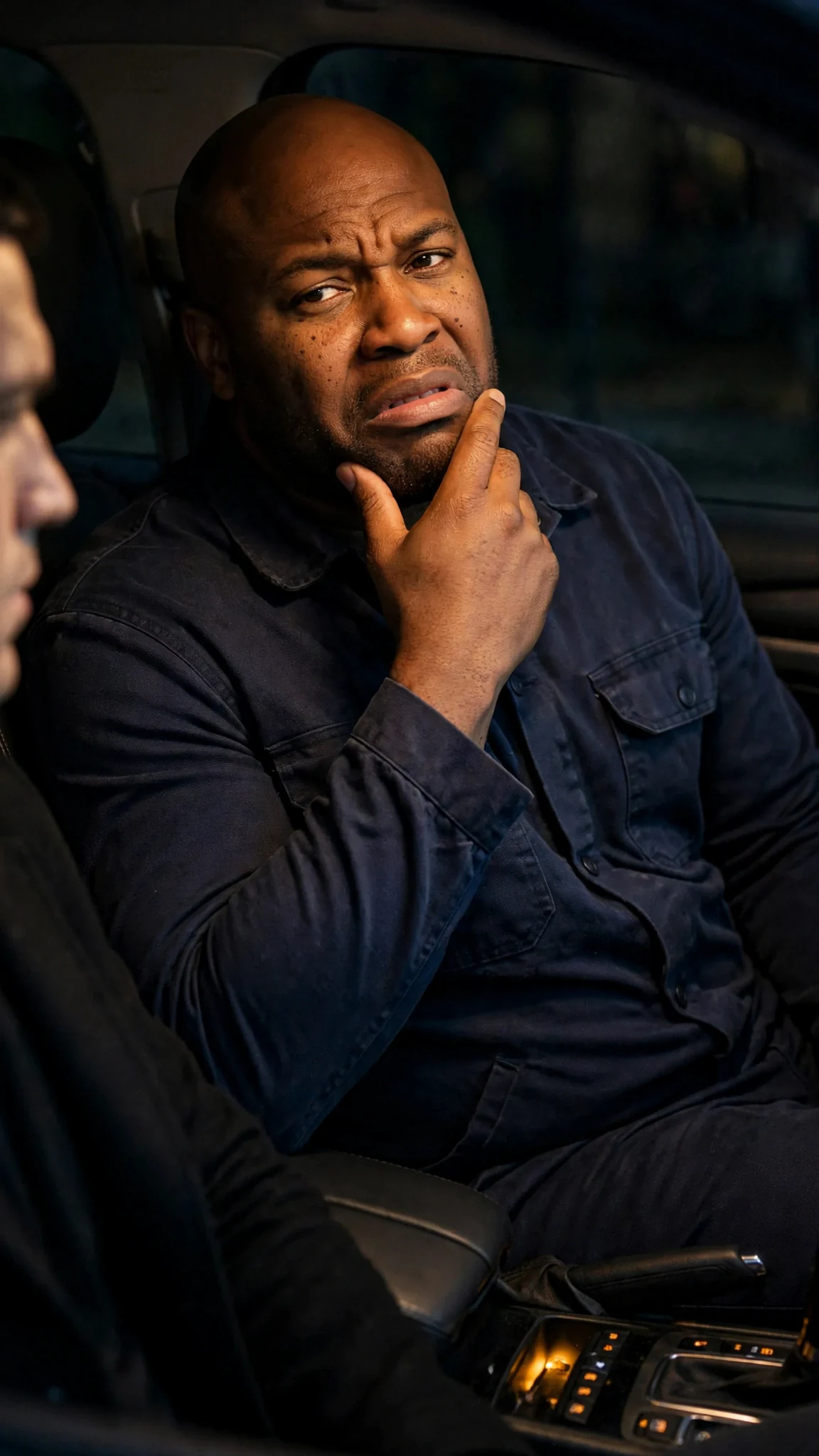 Tate sits back in his seat, rubbing his beard, disbelief all over his face.