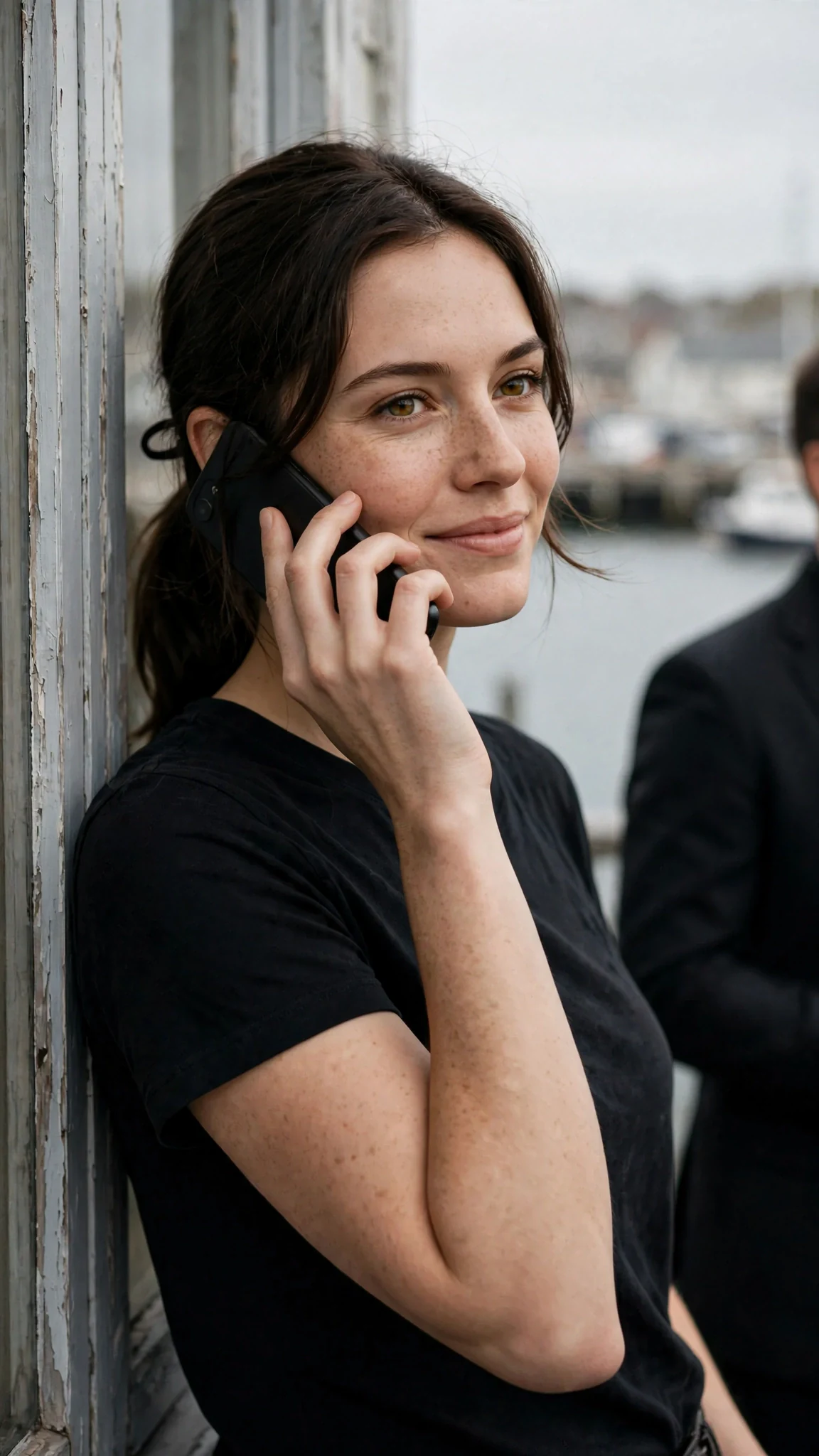 Renata leans against the window frame, phone at her ear, a cold little smile.